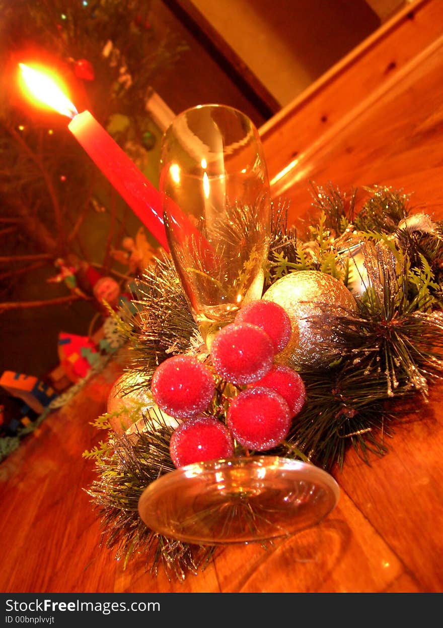 New-year decoration with a candle and glass for champagne. New-year decoration with a candle and glass for champagne