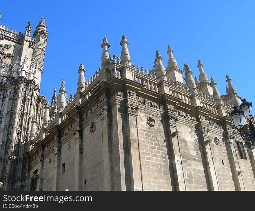 Detail of Catholic cathedral portal against clear blue sky in Spain. Detail of Catholic cathedral portal against clear blue sky in Spain