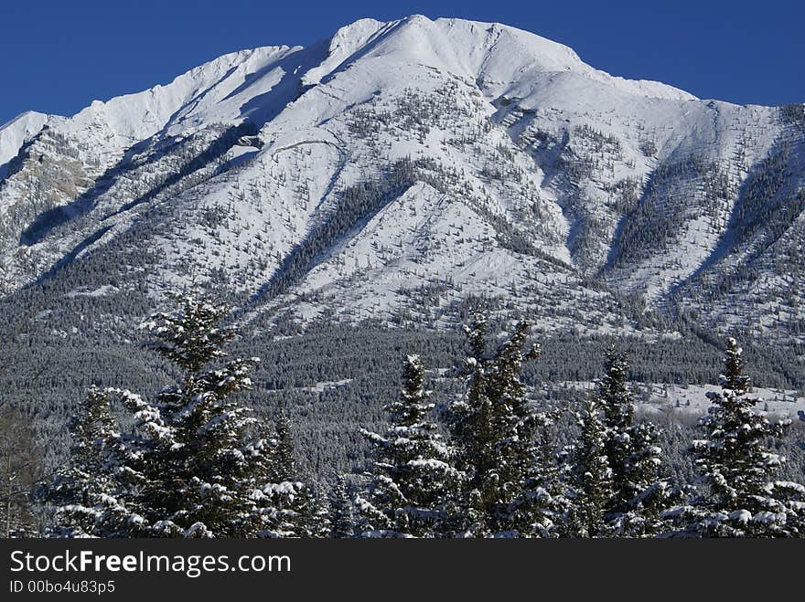 Mountain coveered in fresh snow in Canmore, Alberta. Mountain coveered in fresh snow in Canmore, Alberta.