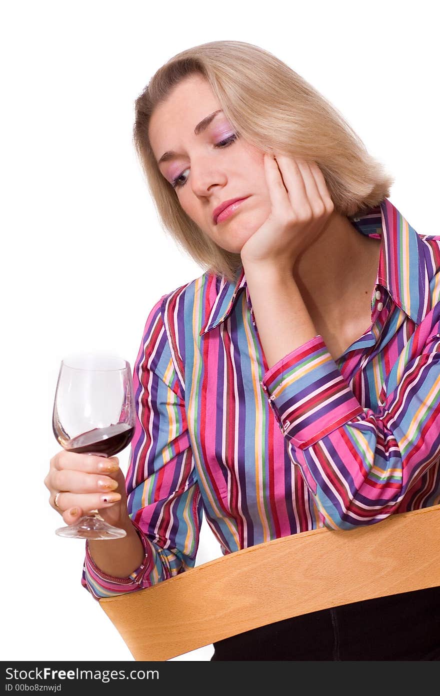 Picture of a sad blond girl with a glass of red wine. Picture of a sad blond girl with a glass of red wine