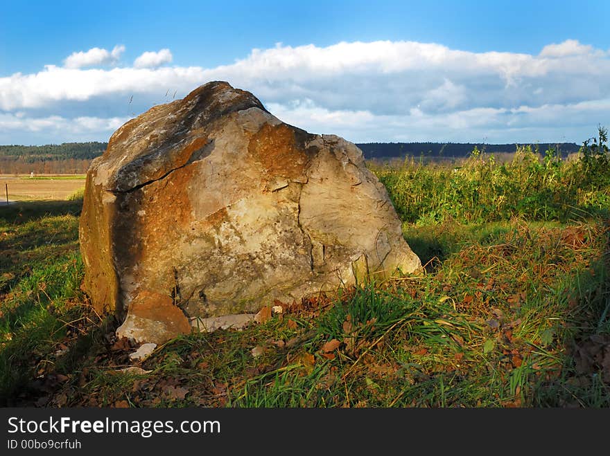 A boulde in a flat landscape. A boulde in a flat landscape.