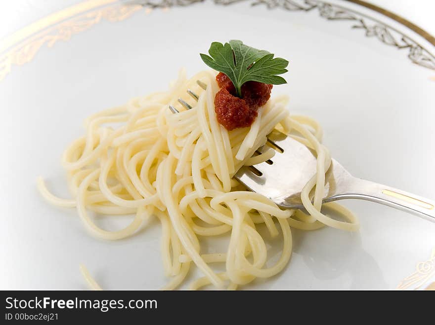 Spaghetti with grawy on the fork close-up