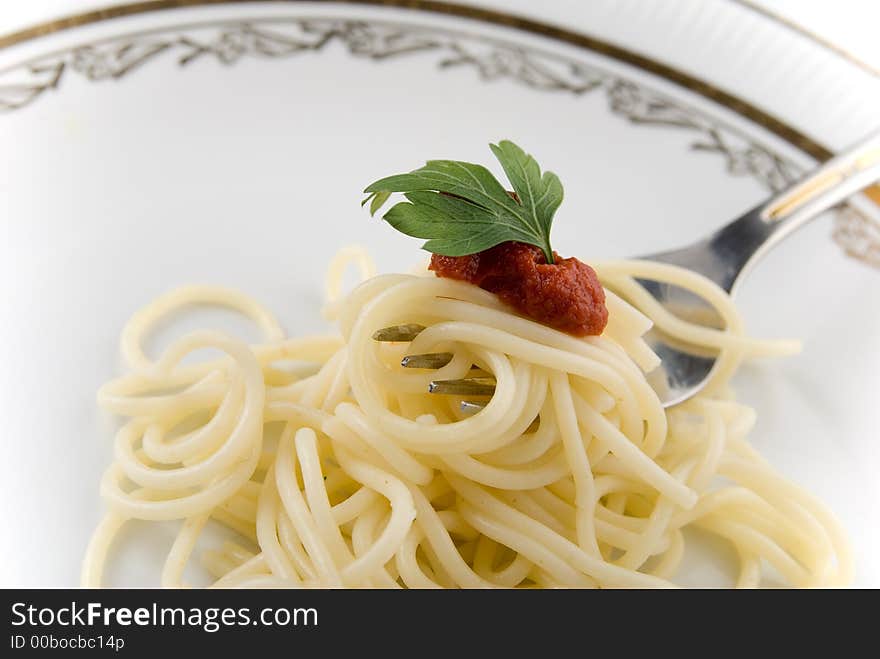 Spaghetti with grawy on the fork close-up