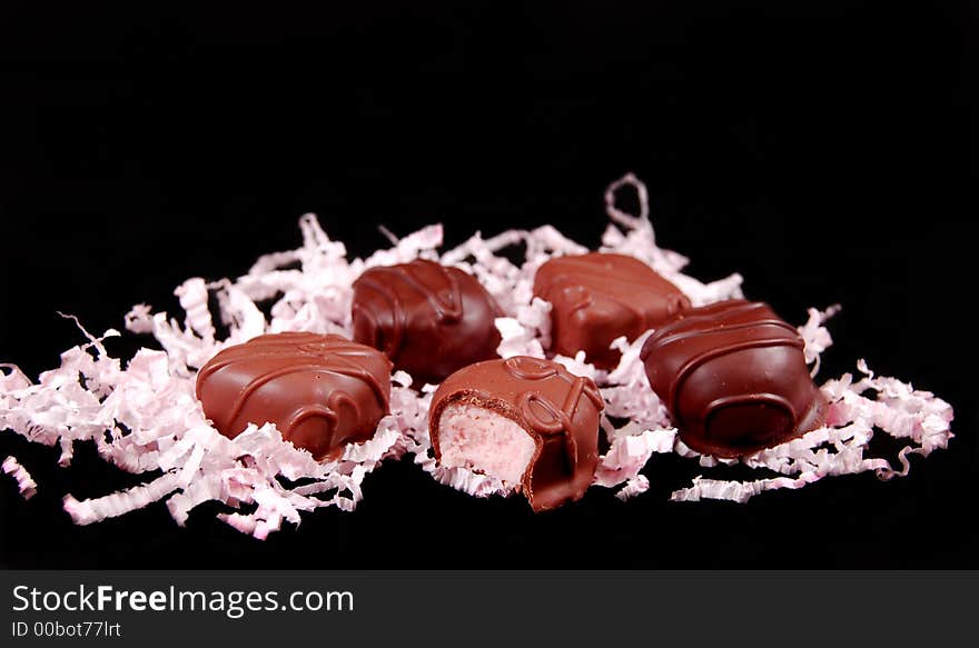 Valentines day chocolates with pink frill on a white background. Valentines day chocolates with pink frill on a white background