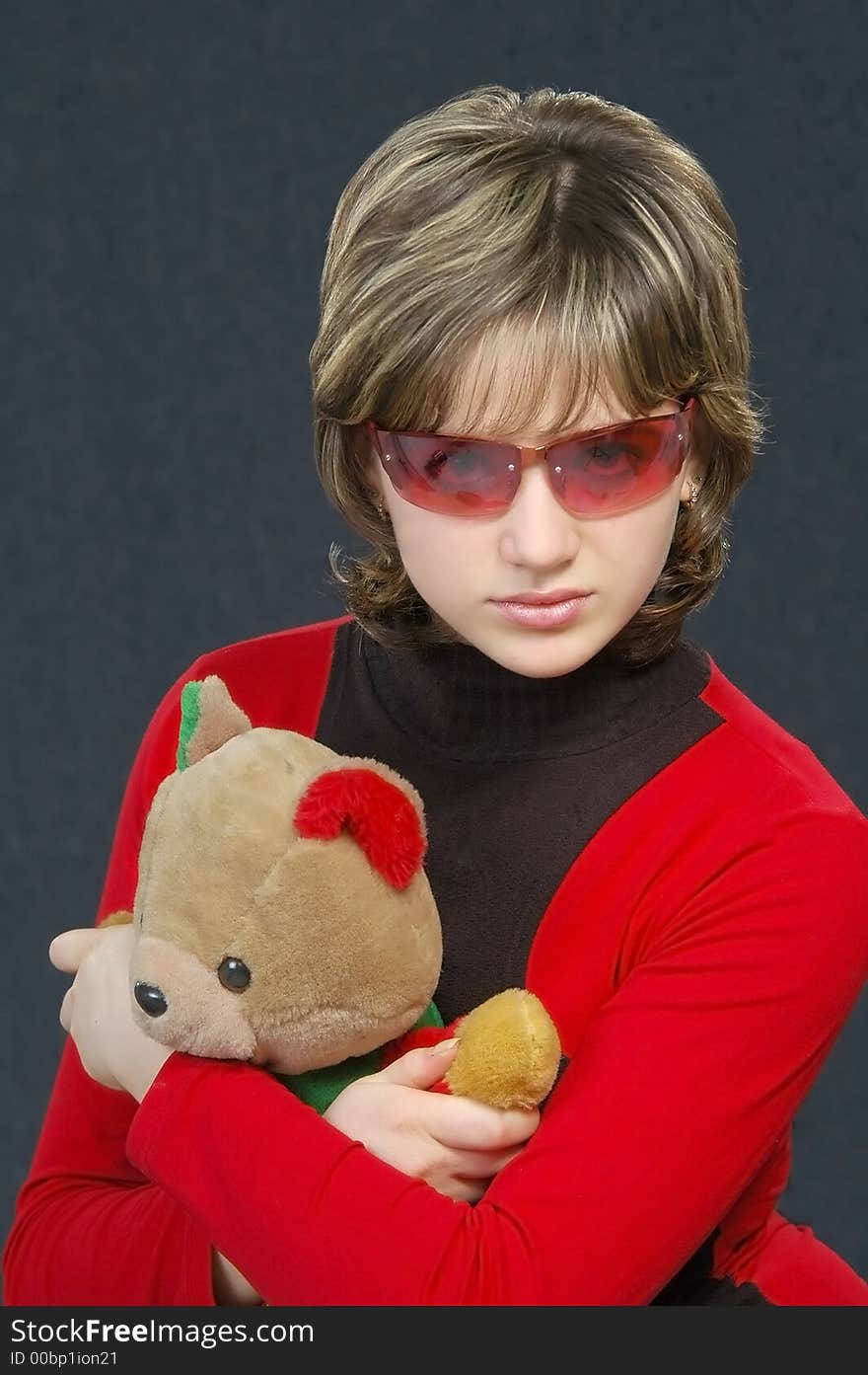 Beautiful girl with a toy in red and black