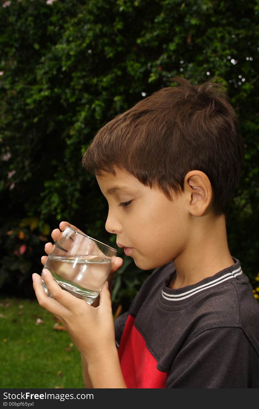 Child drinking a glass of fresh water. Child drinking a glass of fresh water