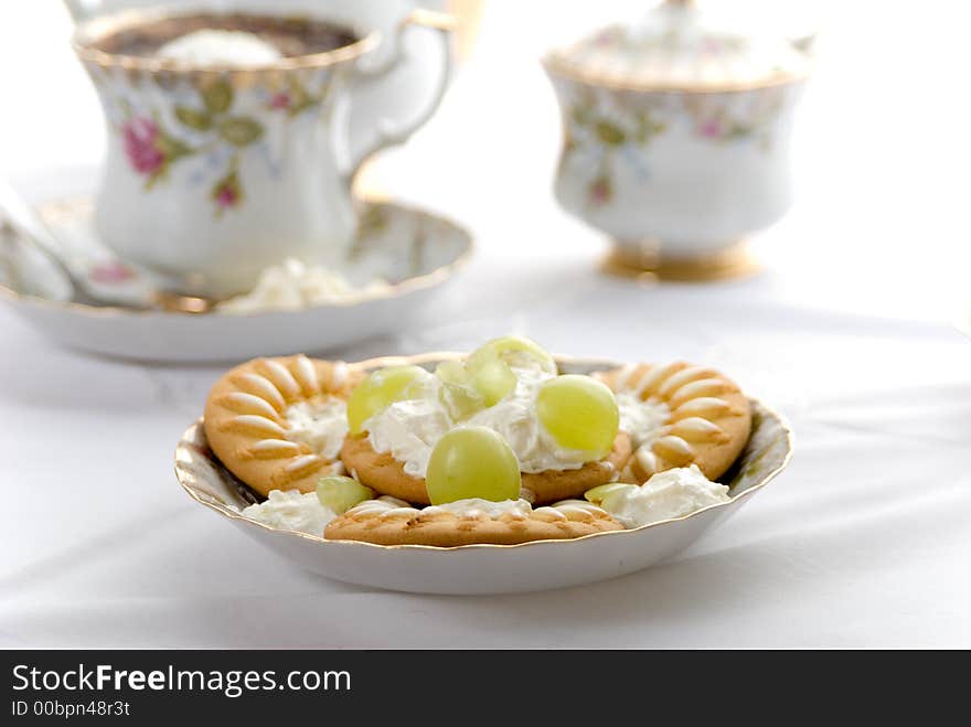 Cookies and cofe in porcelain pot.