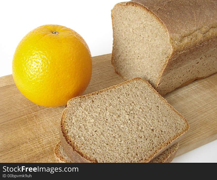 Black bread and whole orange. Black bread and whole orange