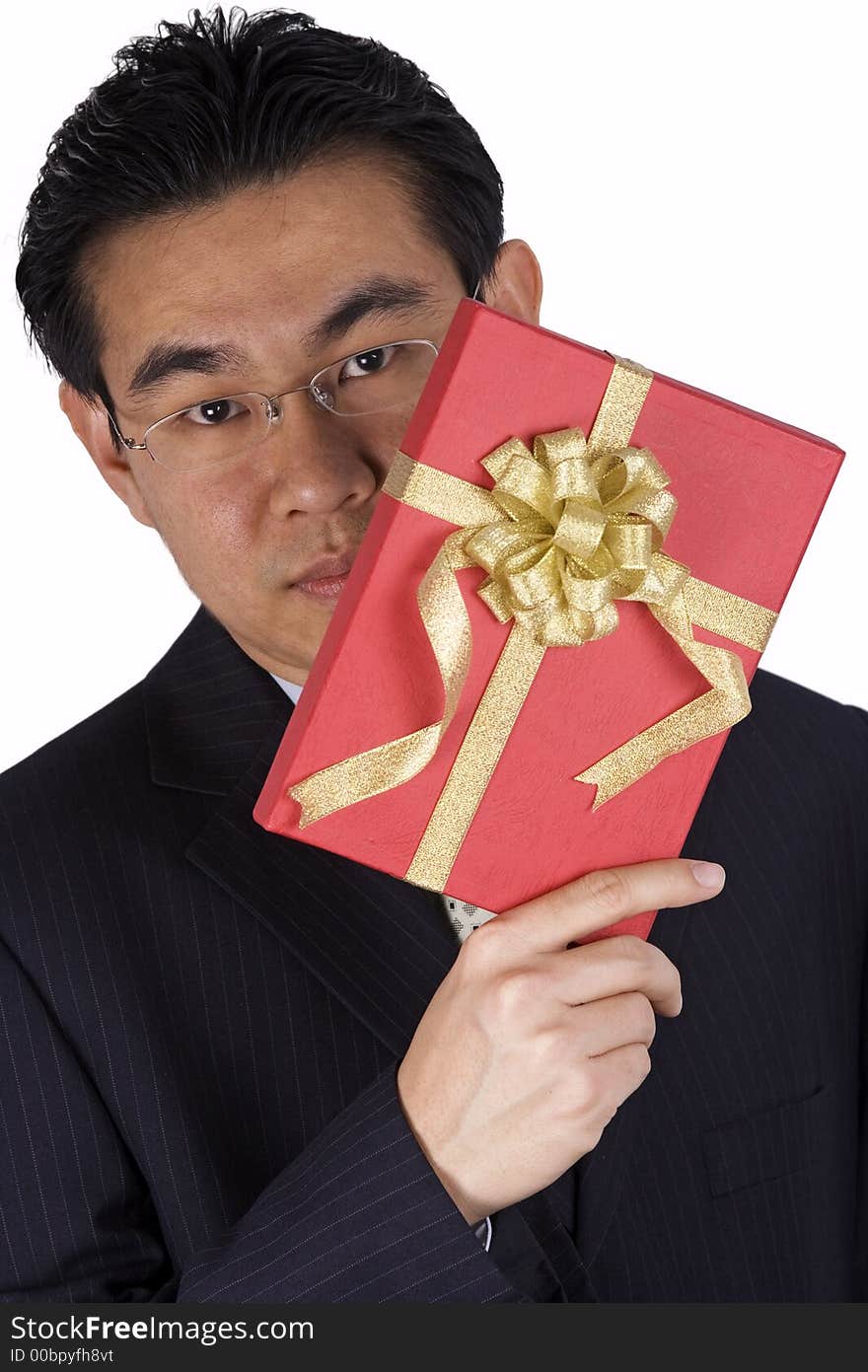 A chinese businessman holding a red present. A chinese businessman holding a red present.