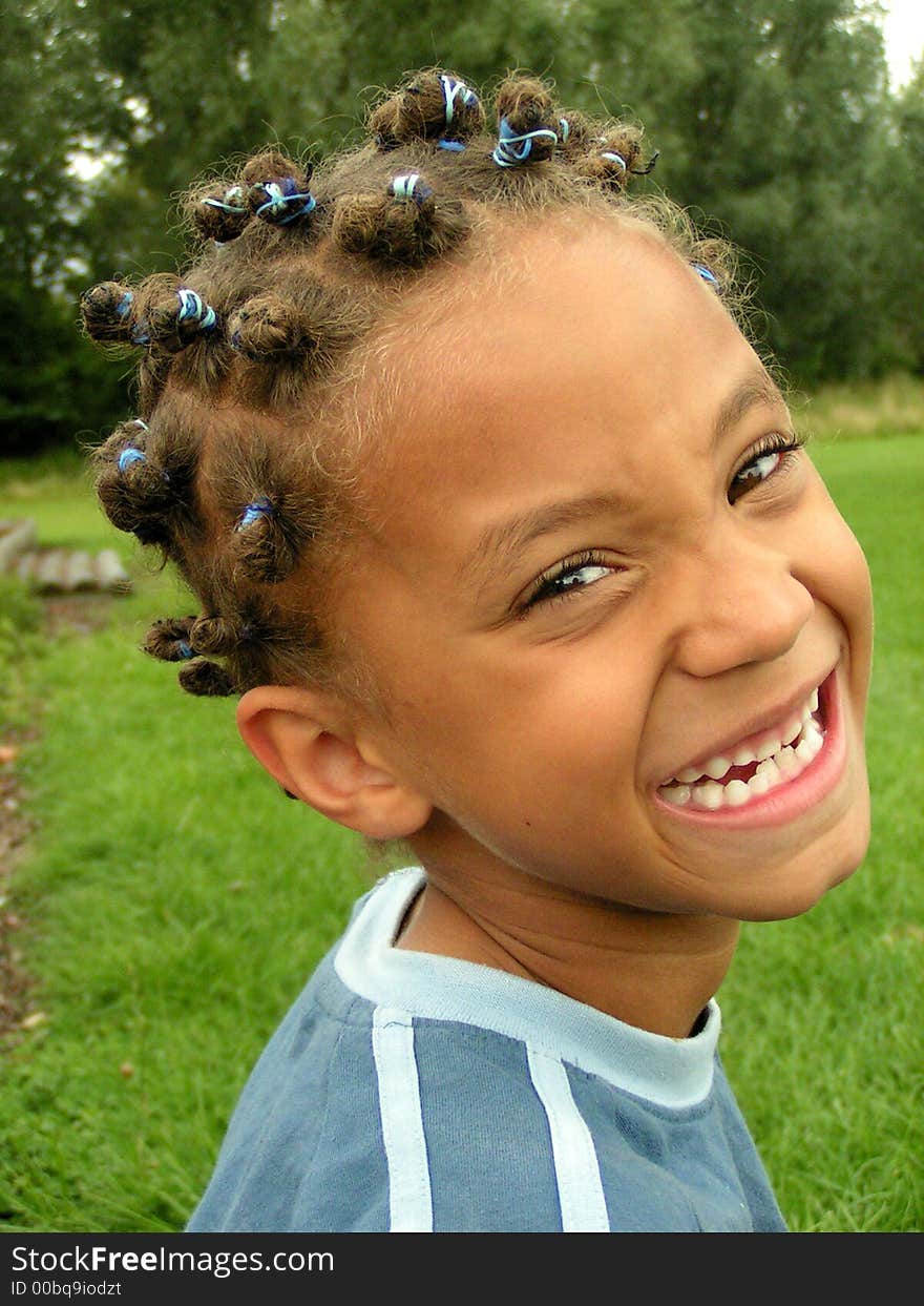 Young smiley brown boy, with hair knots and blue hairbands. Young smiley brown boy, with hair knots and blue hairbands.