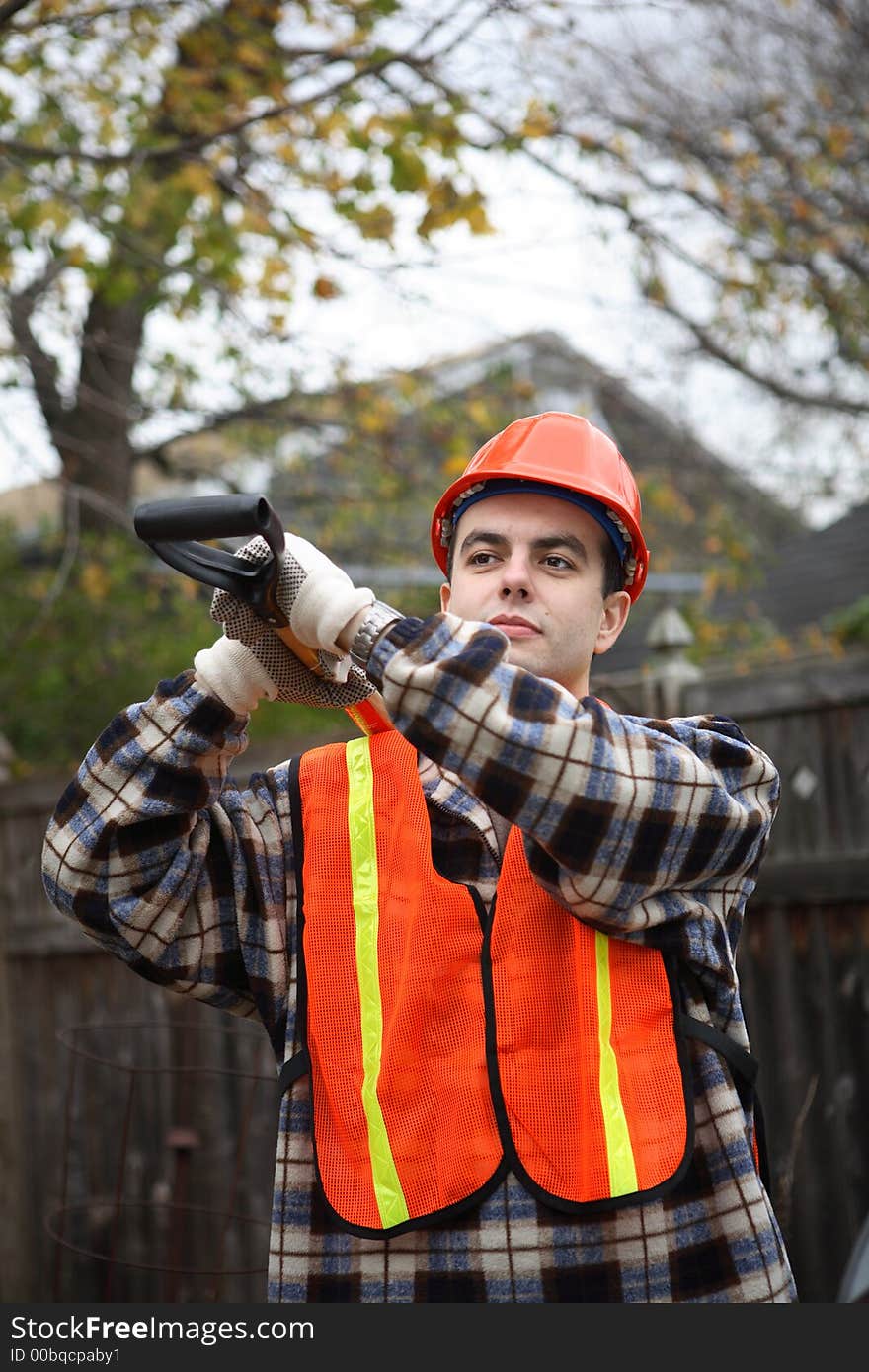 Construction worker holding shovel with both hands on his shoulder. Construction worker holding shovel with both hands on his shoulder