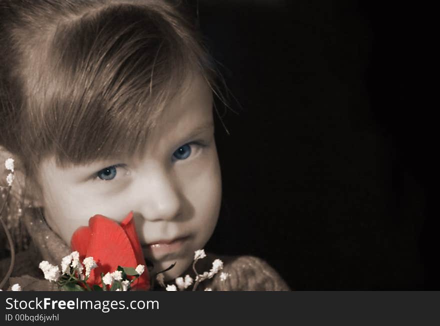 Pretty little girl with serious expression, holding a red rose. Pretty little girl with serious expression, holding a red rose.