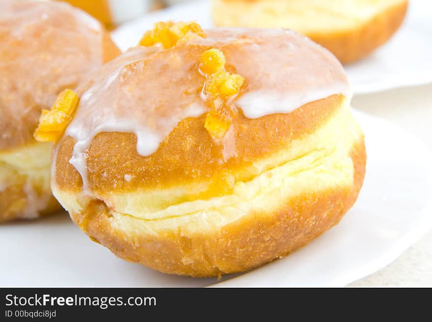 A tasty icing donut with orange zest. A tasty icing donut with orange zest.