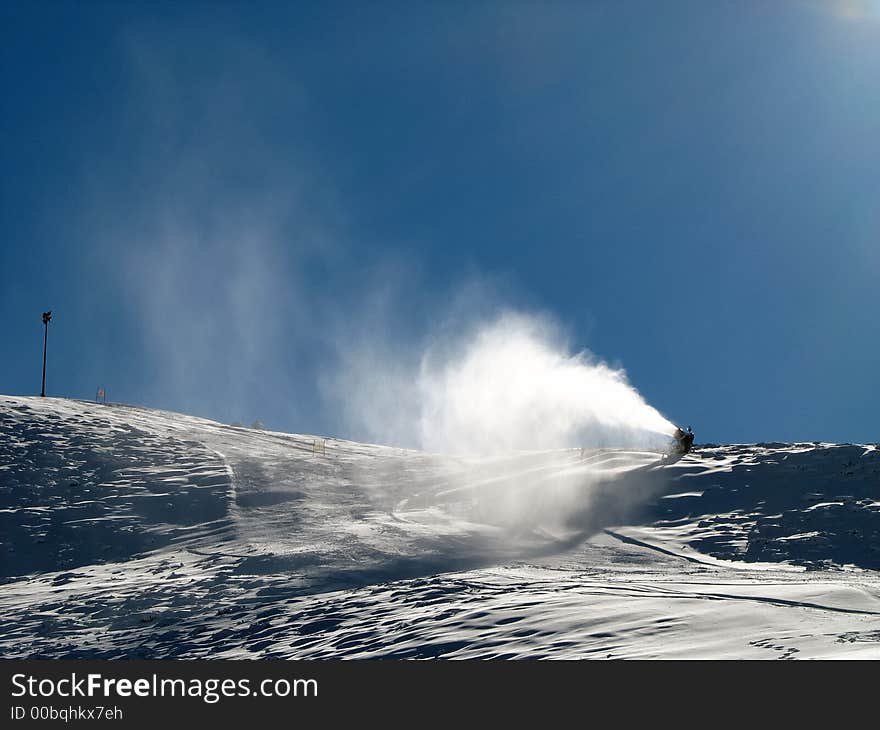 Snow-gun working on a ski slope ,Alps ski resort. Snow-gun working on a ski slope ,Alps ski resort