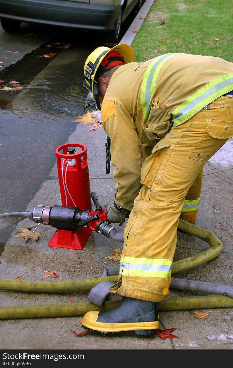 Fireman setting a water supply. Fireman setting a water supply