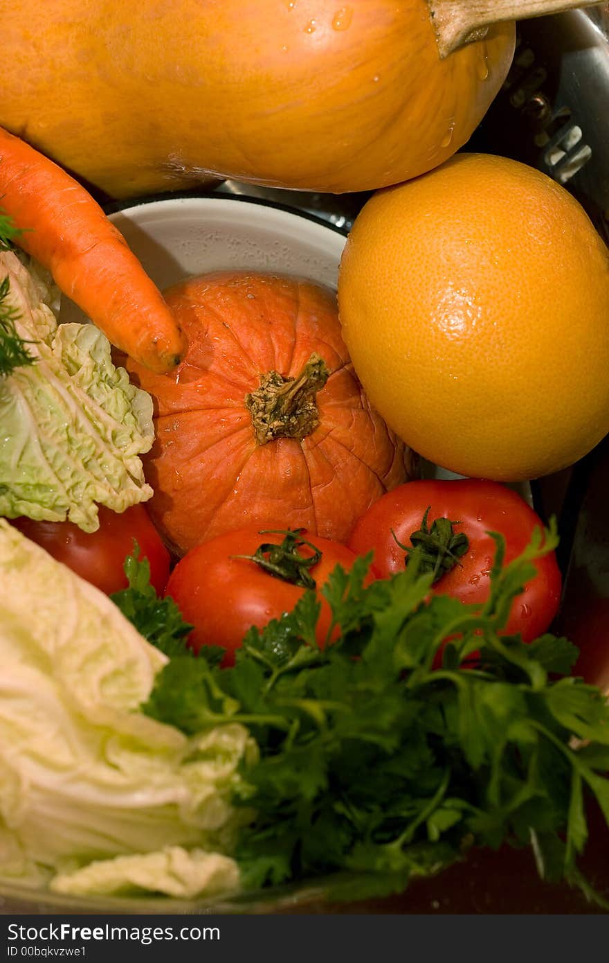 Fresh vegetables - tomatoes, cabbage, carrot, parsley, pumpkin - on the plates