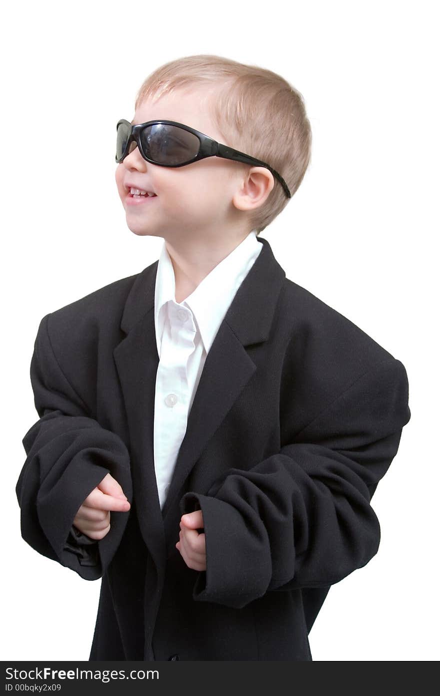 Happy business boy is wearing a big black suit; isolated on white. Happy business boy is wearing a big black suit; isolated on white