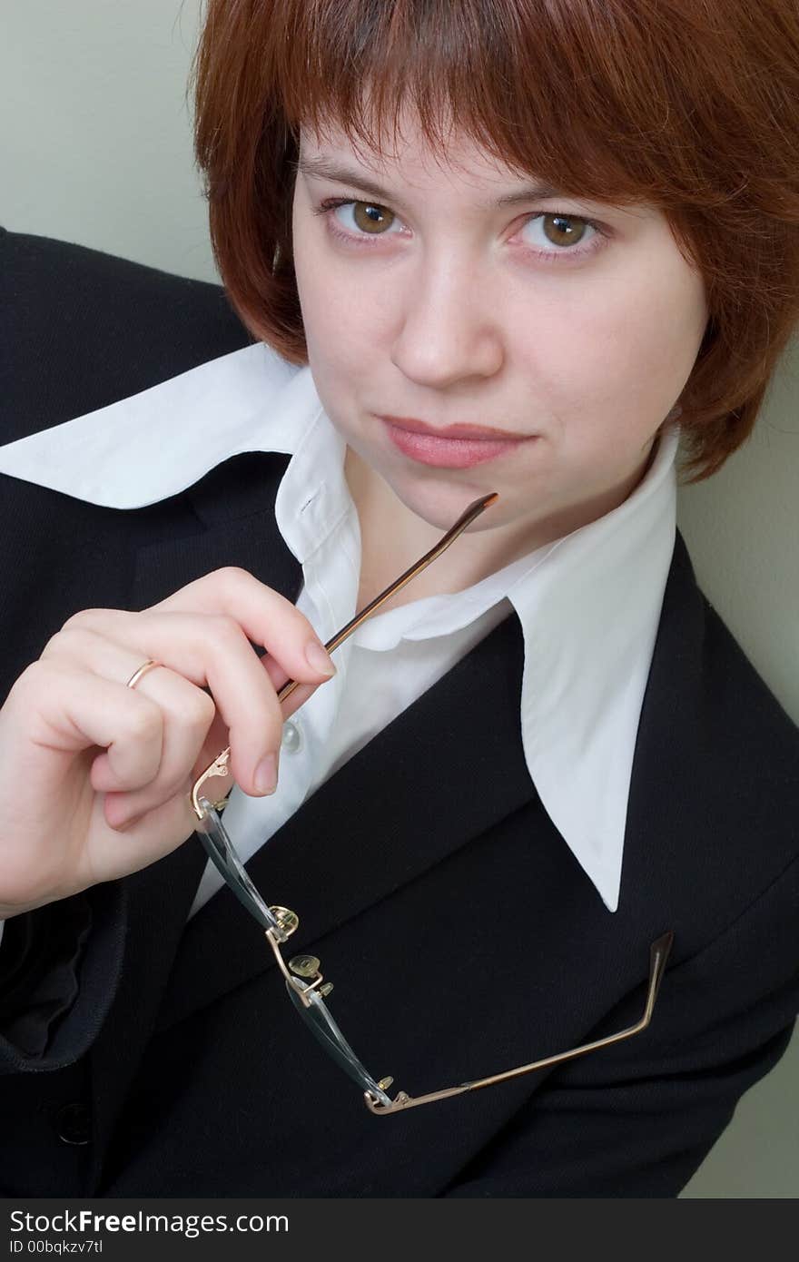 Portrait of thoughtful business lady, looking to the camera. Portrait of thoughtful business lady, looking to the camera