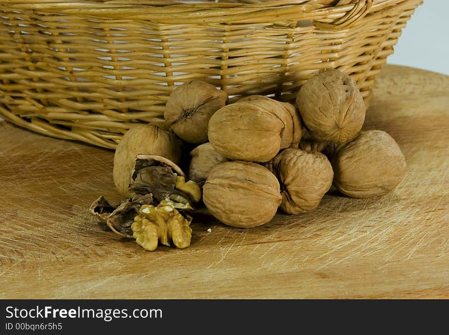 Walnuts in front of a litle basket. Walnuts in front of a litle basket