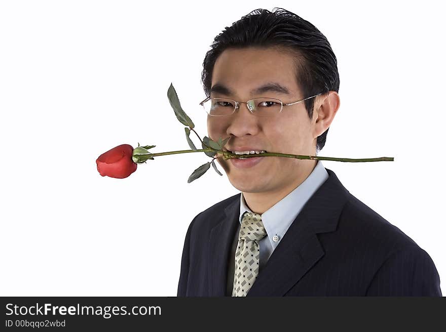 Asian young guy holding rose in mouth.