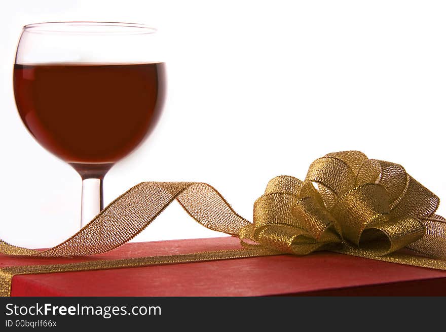 Red wine and red gift box with golden ribbon. Red wine and red gift box with golden ribbon.