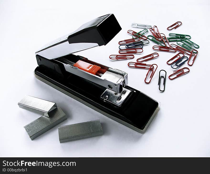 Stapler and clamps on the white background. Stapler and clamps on the white background