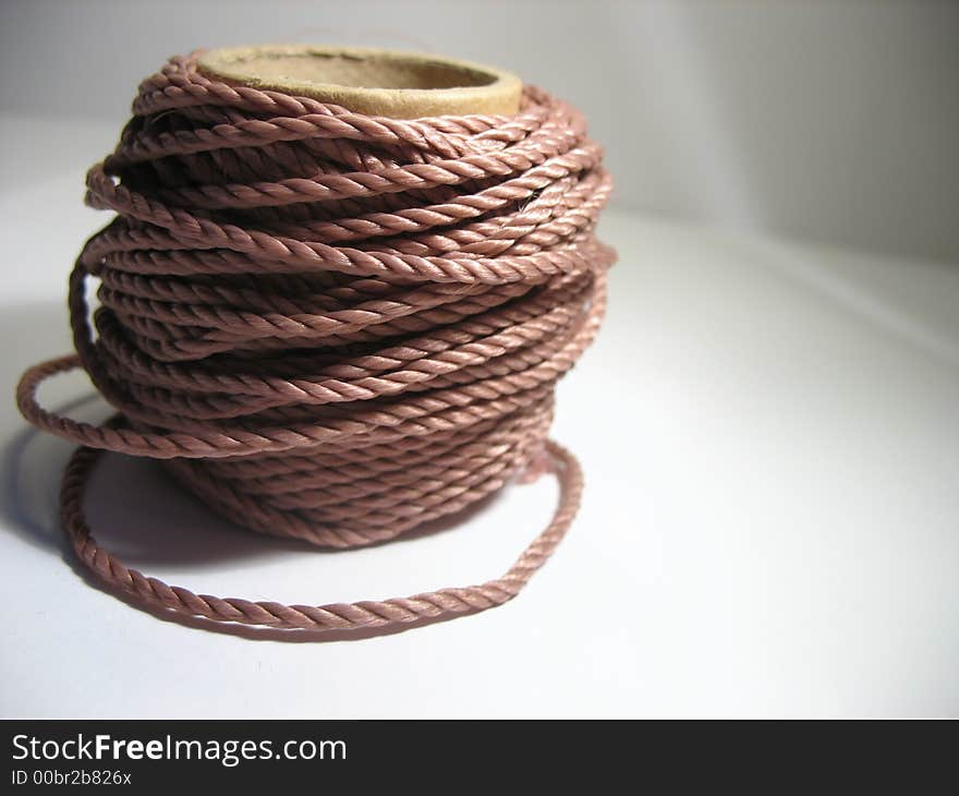 Ball of a cord laying on a table. Ball of a cord laying on a table.