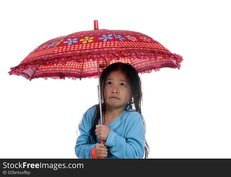 A young girl is wet, cold and scared under an umbrella. A young girl is wet, cold and scared under an umbrella