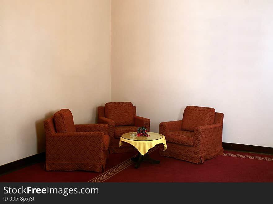 Comfortable place - armchairs in the corner with small table in front cover with yellow. Comfortable place - armchairs in the corner with small table in front cover with yellow