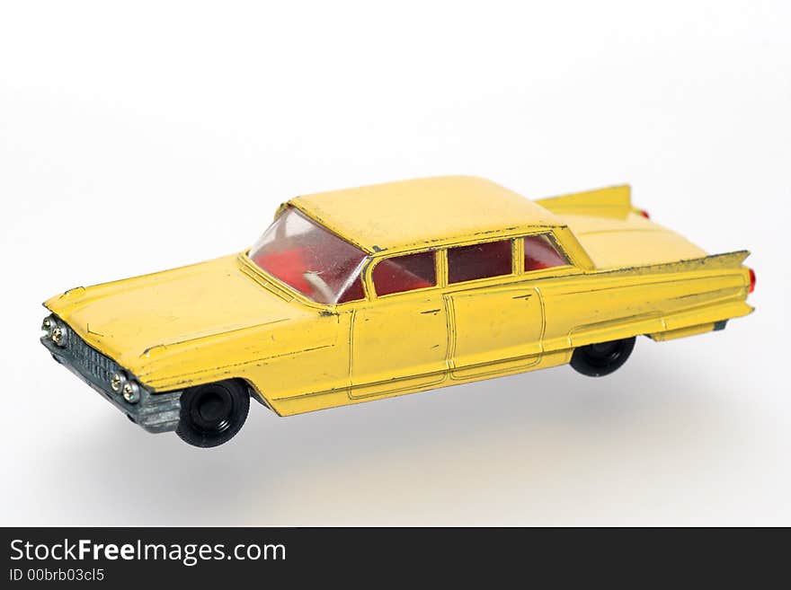 Old abused yellow toy Cadillac