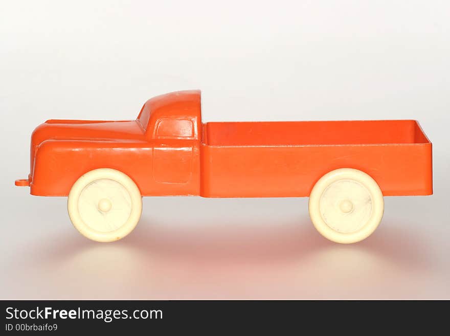 Nice orange plastic toy truck sideview