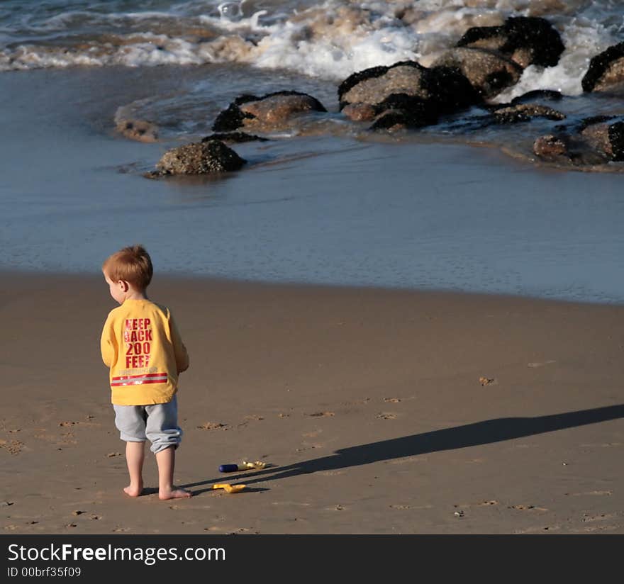 Young boy visiting the beach. Young boy visiting the beach