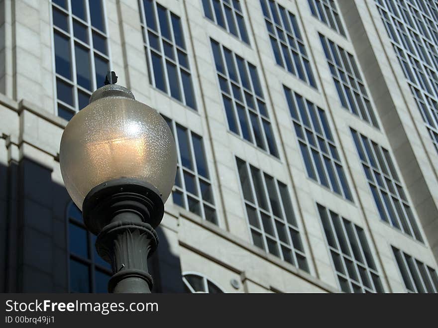 Facade of a modern office building behind a traditional street lamp