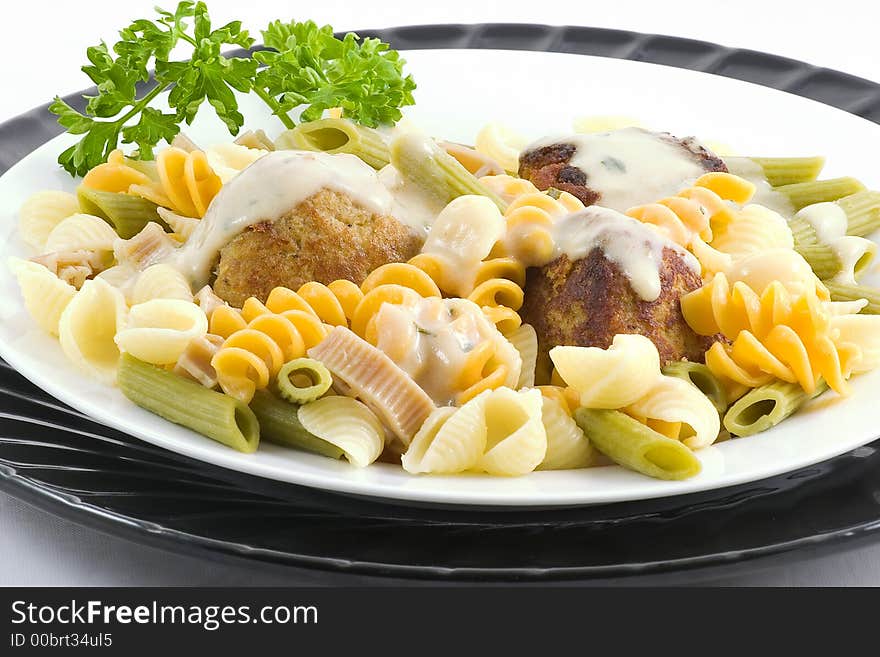 For a change I served swedish meat balls (made extra when I made the spaghetti and meat balls) over a bed of colorful pasta garnished with parsley.