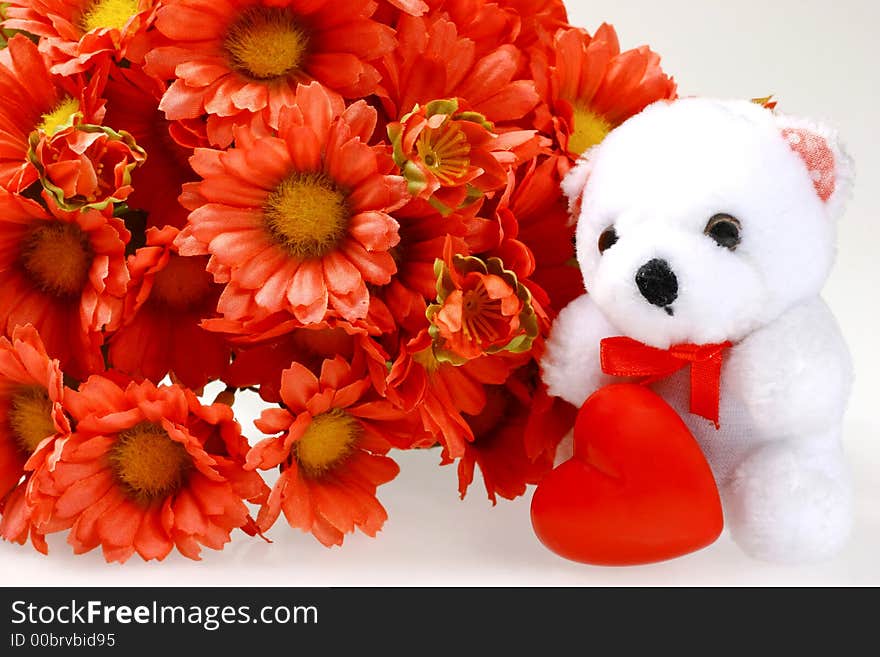 Teddy bear with heart and flowers