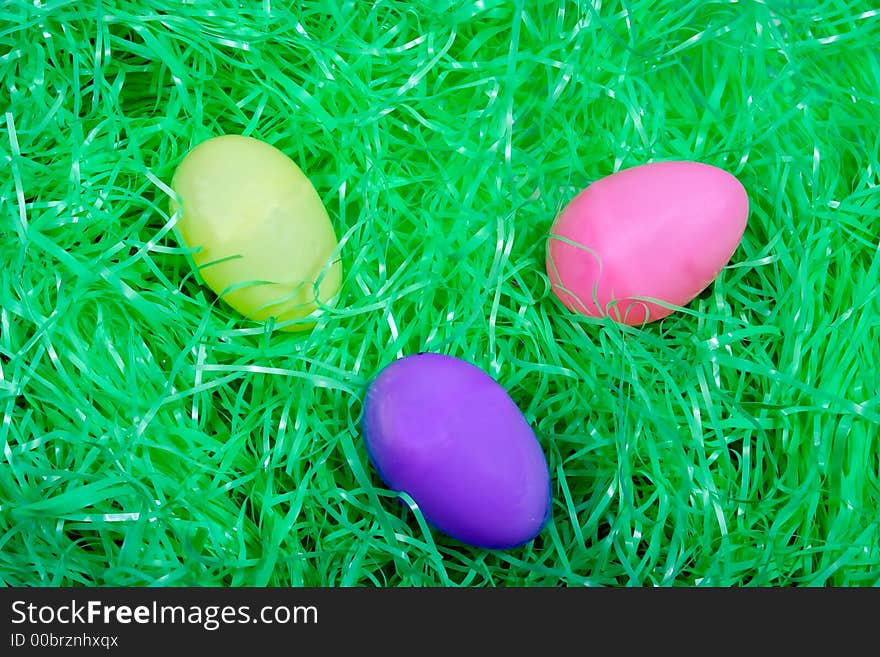 Colored Easter eggs on bed of easter grass. Colored Easter eggs on bed of easter grass