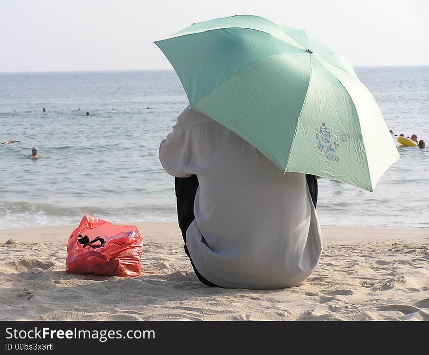 Local watching the tourists in the sea