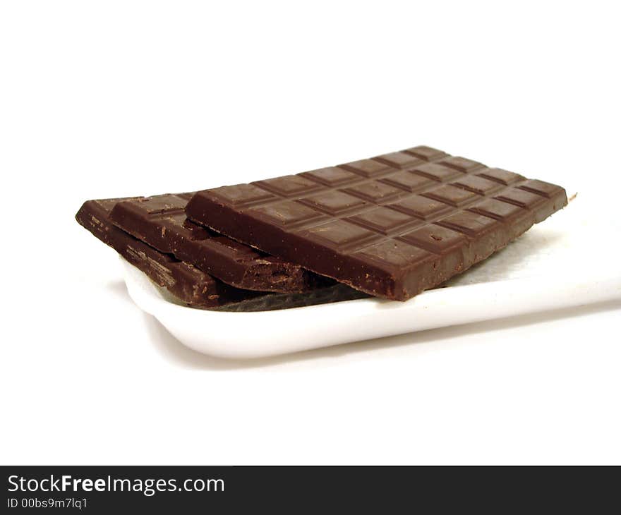 Chocolate on a plate over white background