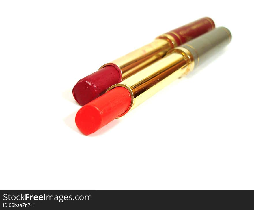 Two red lipstick on white background