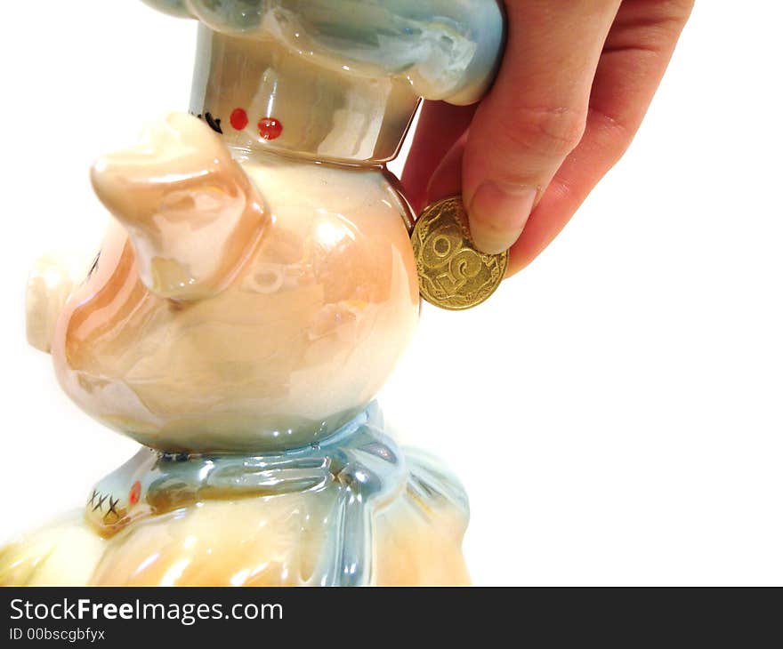 Hand put money in piggy ceramic bank for money over white background