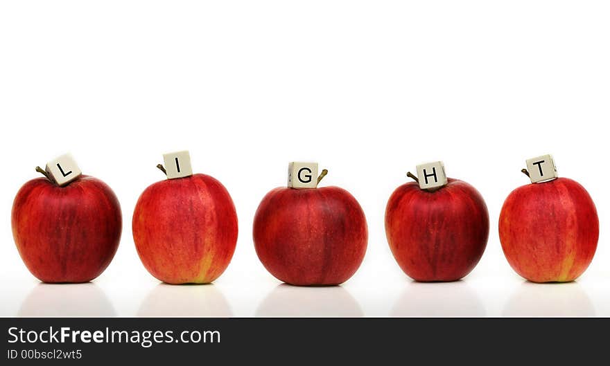 Red apple and cubes with letters in front of a white background - light. Red apple and cubes with letters in front of a white background - light