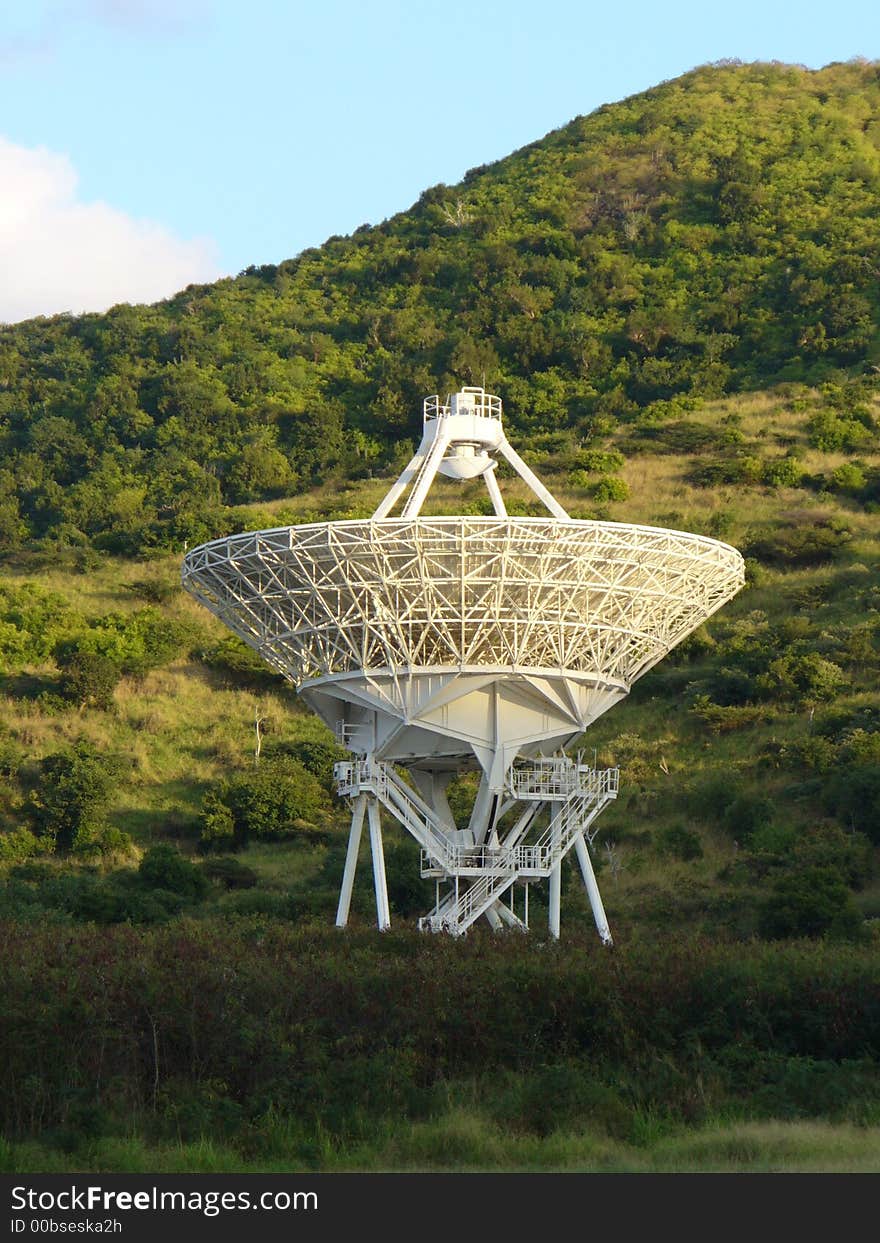 Radio telescope satellite dish against a hillside