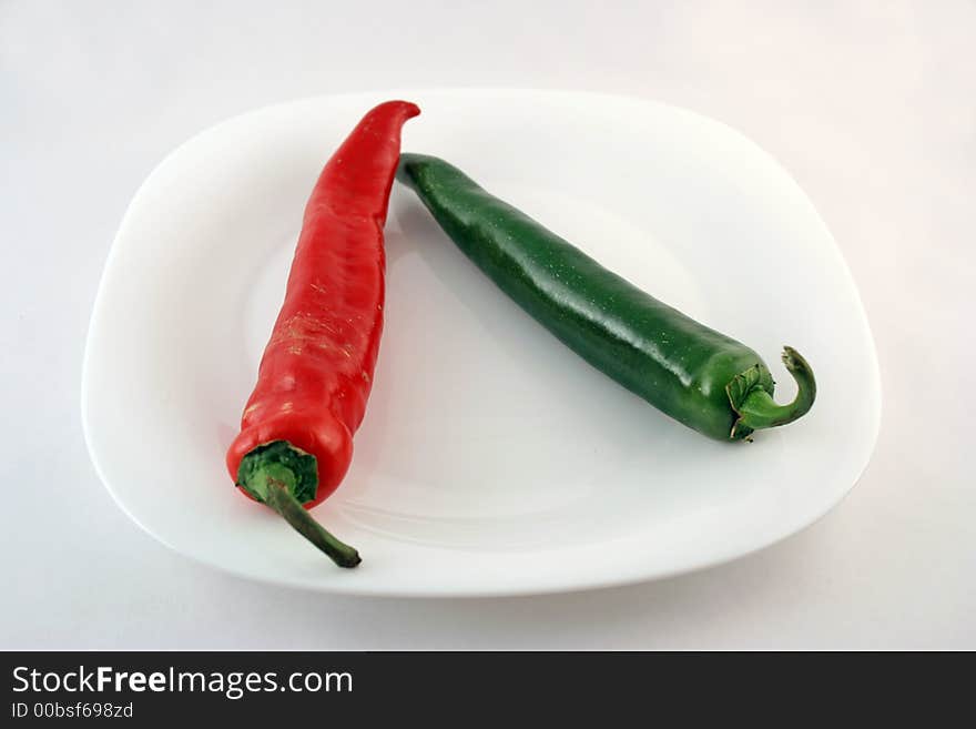 Red and green pepper on a plate