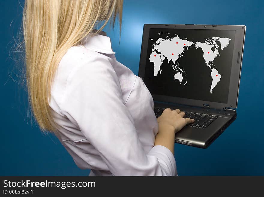 Woman is holding laptop with world map on the screen. Woman is holding laptop with world map on the screen.