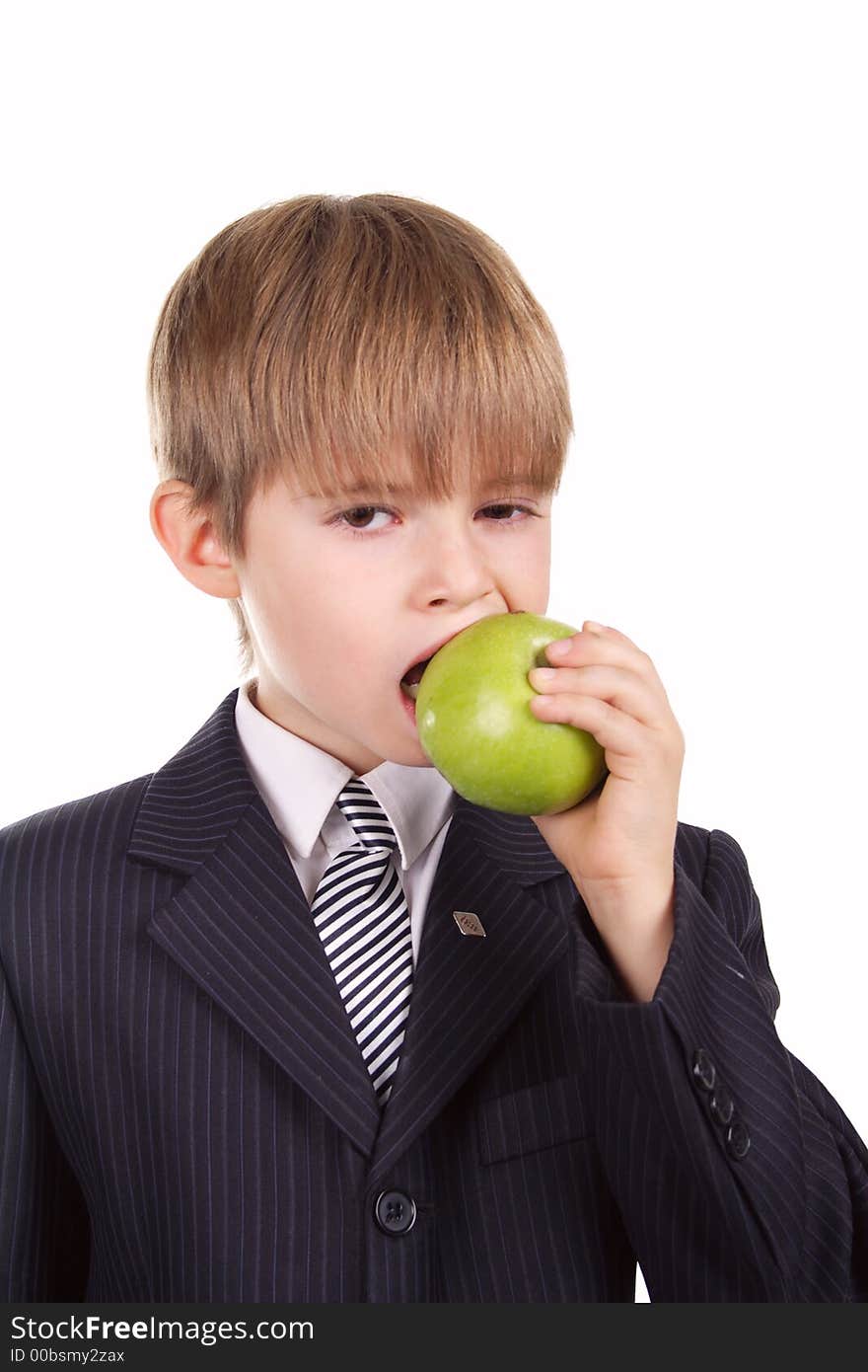 A young boy with his apple, against white background.