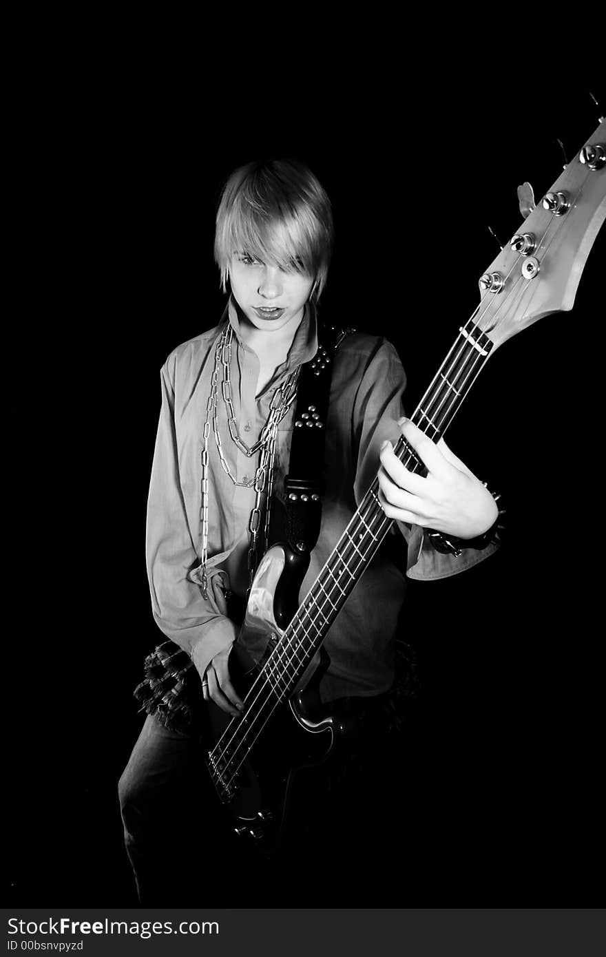 A young woman playing her guitar with expression. A young woman playing her guitar with expression.