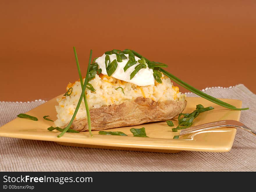 Twice baked potato with chives and sour cream