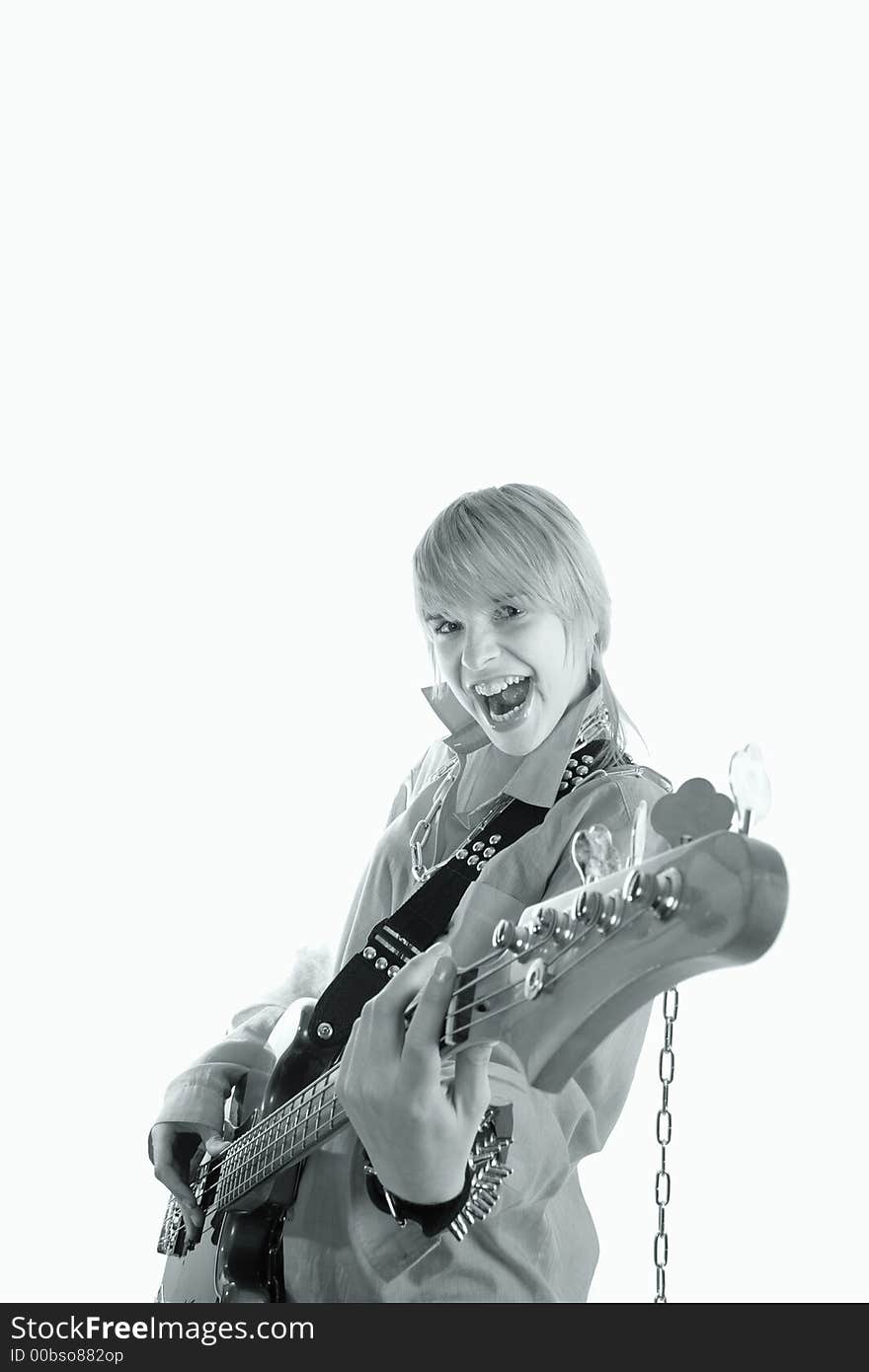 A young woman playing her guitar with expression. A young woman playing her guitar with expression.