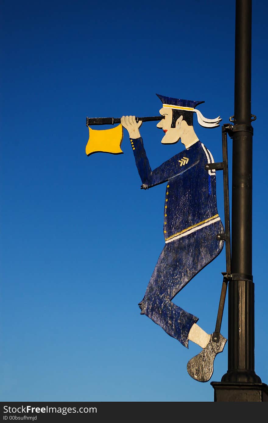 Wooden ship's mascot of sailor looking to the horizon fstened on the mast. Wooden ship's mascot of sailor looking to the horizon fstened on the mast