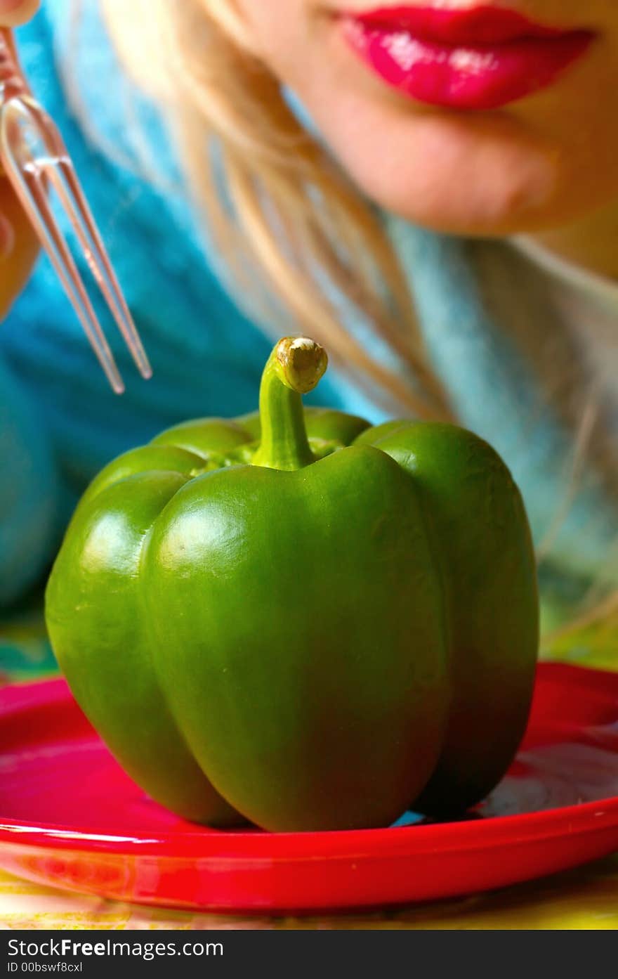 Green Pepper On The Red Plate